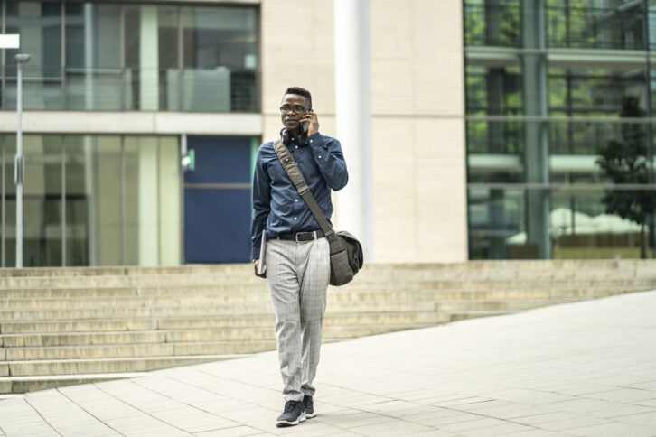 African man talking by phone in business lanscape