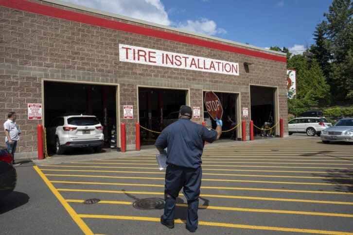 Clackamas, OR, USA - Jun 8, 2021: A car is seen backing out of the workshop after tire installation at the Costco Wholesale Store in Clackamas, Oregon.