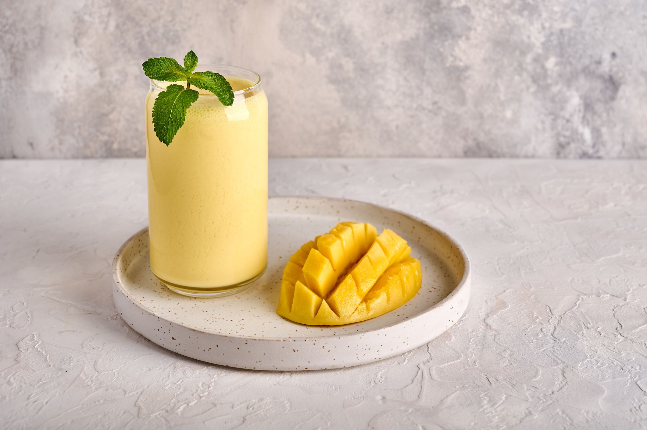 Lassi is popular traditional refreshment cold drink with yogurt, mango, water, spices and ice. Copy space