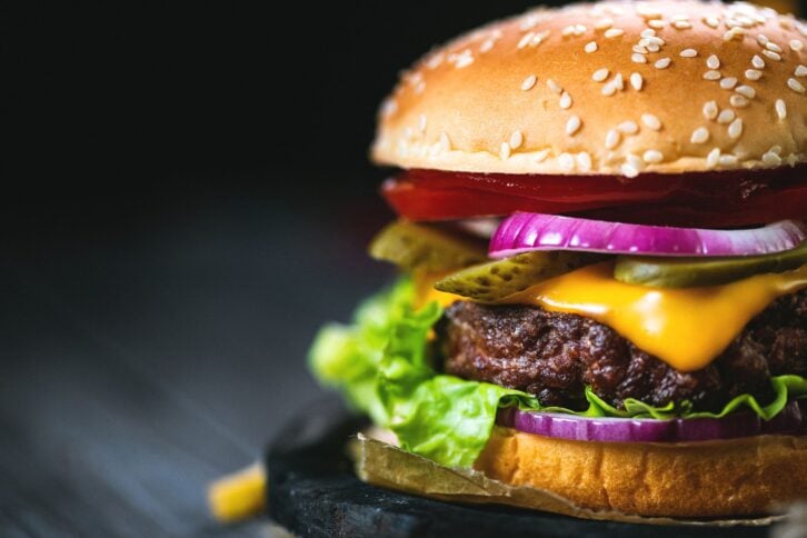 Tasty hamburger with french fries ready to eat