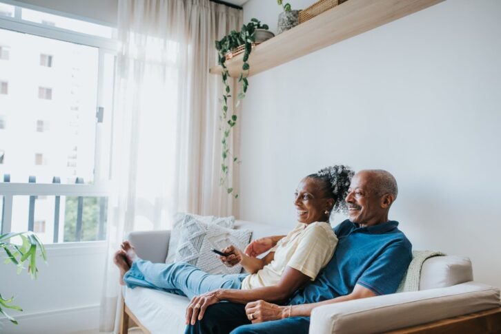 senior couple watching tv