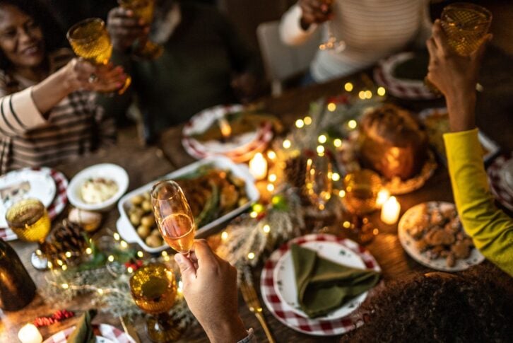 Family toasting on Christmas dinner at home