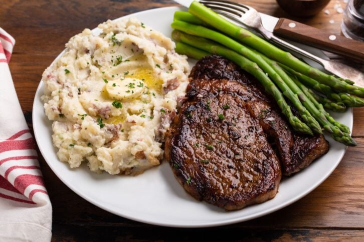 Traditional steak and mashed potatoes with blanched asparagus