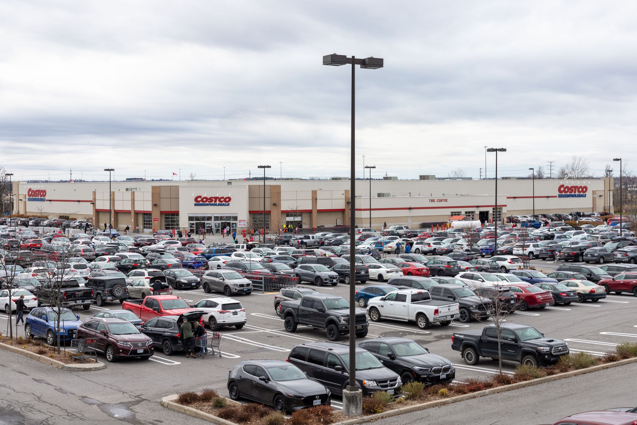 Kanata, Canada - November 20, 2021: Parking lot full of cars near Costco Wholesale warehouse store on a busy shopping Saturday