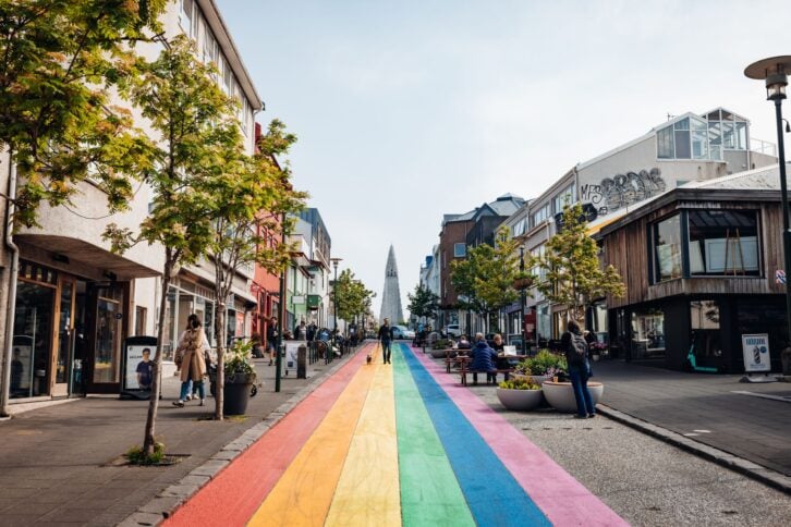 Reykjavik, Iceland - July 5th, 2021: View up the famous Rainbow Street in Downtown Reykjavik Iceland. Halgrimskirka in the background. Reykjavik, Iceland, Northern Europe