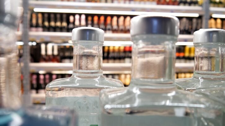 Beautiful bottles of gin or vodka on a store shelf close-up