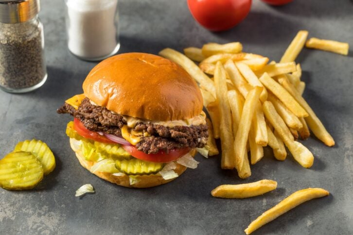 Homemade Cheese Smash Burger with Fries Pickles and Tomatoes