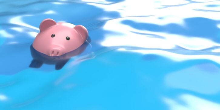 Global recession or bankruptcy 3D concept: Financial and economy crises. Rising inflation.  Piggy bank drowning in debt - savings to risk background with large copy space. Money loosing value and investments failed.