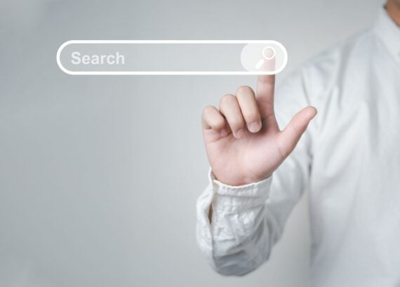 Man standing with hands pointing to information search is a data clicking to virtual internet search page computer touch screen. Education, Knowledge, Analysis the Internet to connect wirelessly.