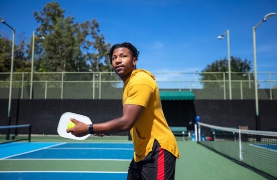 Portrait of a sporty Cape Verdean man in his 20s playing pickleball.