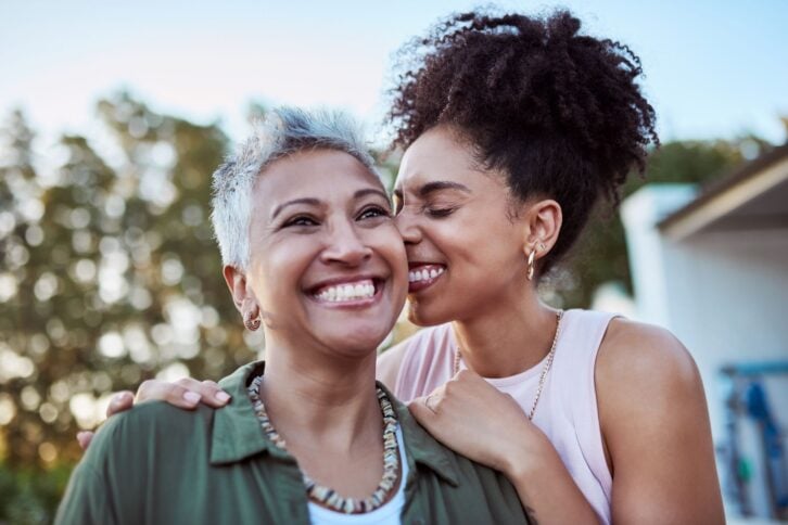 Smile, mother and child in a garden for love, peace and care together on mothers day. Happy, relax and calm woman with  affection for her senior mom at a home for people in retirement in a backyard