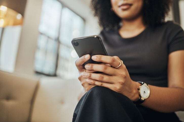 Mobile phone, hands and woman using 5g network connection for communication, social media or banking app. Black female typing and reading on smartphone for internet game, chatting or online shopping