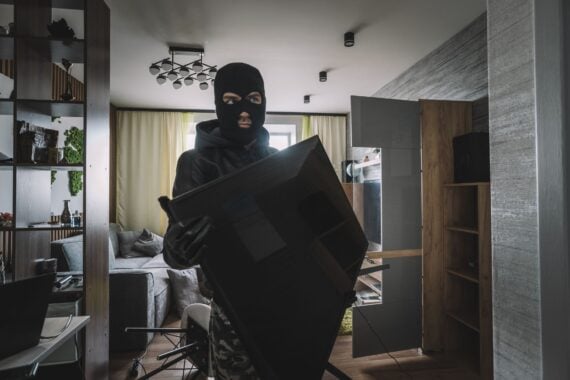 marauder takes the TV out of an empty apartment. Apartment theft concept. The burglar.