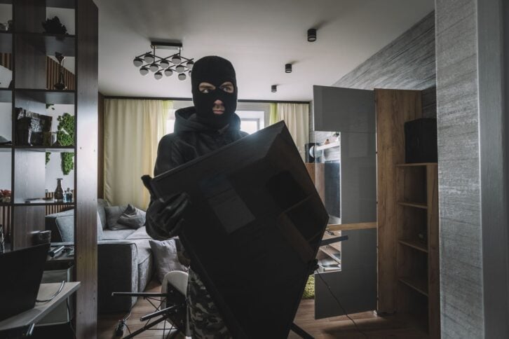 marauder takes the TV out of an empty apartment. Apartment theft concept. The burglar.
