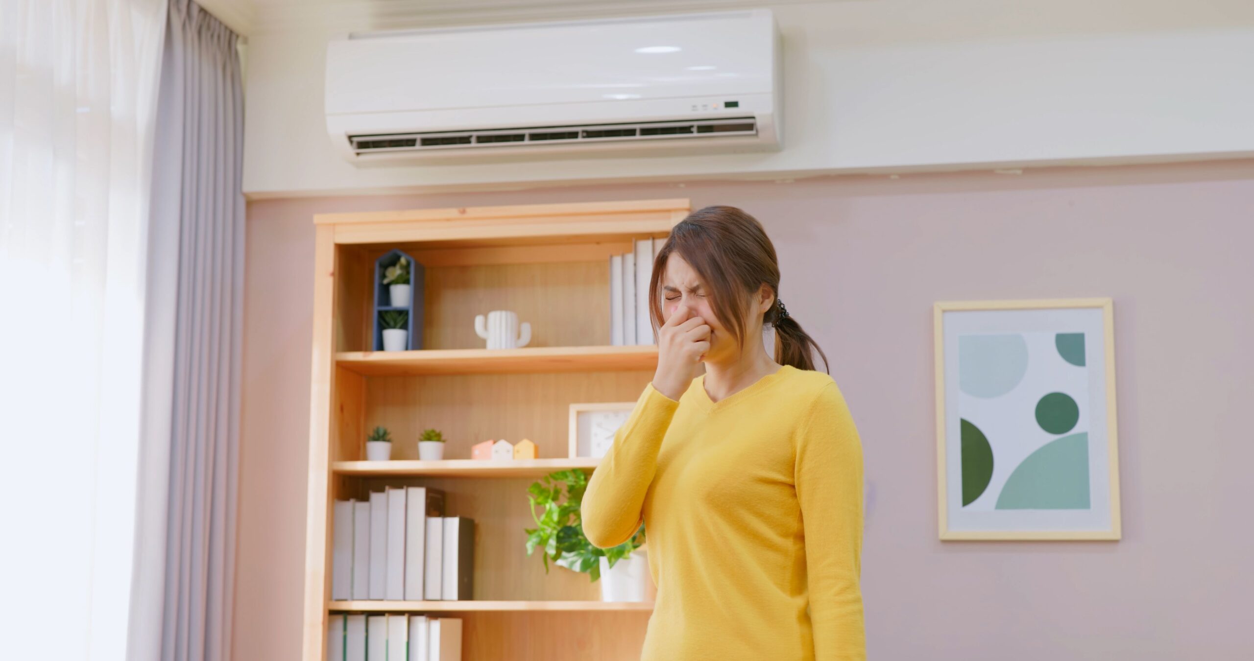 asian woman feel annoyed and she is suffering bad smell from heating or ac at home - trying clinch nose holding breath