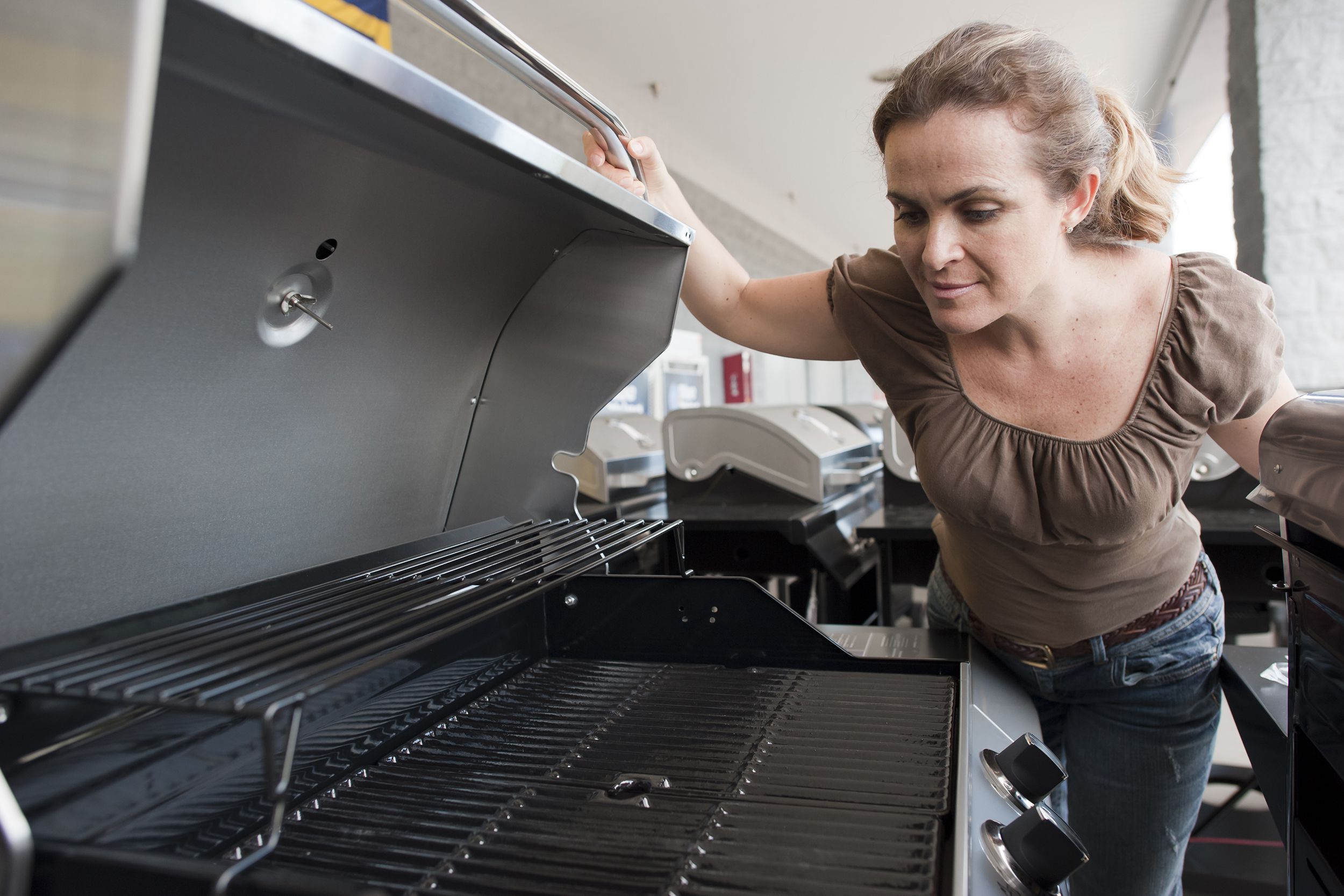 woman shopping for a new barbecue grill