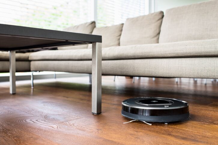 robot vacuum cleaner cleaning living room