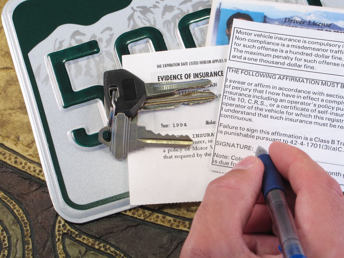 An image of someone filling out their vehicle registration.
