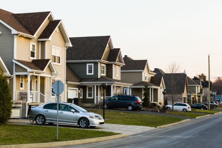Homes in a row. Suburb. family car. Driveway.