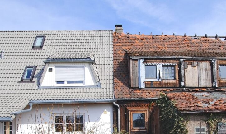 new house next to run-doen old house