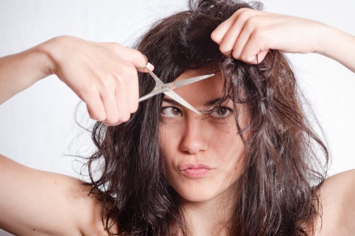 woman cutting her own hair