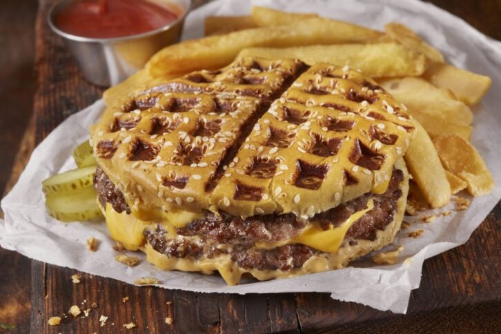 Crispy Copycat Waffled Cheese Burger on a Sesame Seed Bun with American Cheese, Burger Sauce and Fries