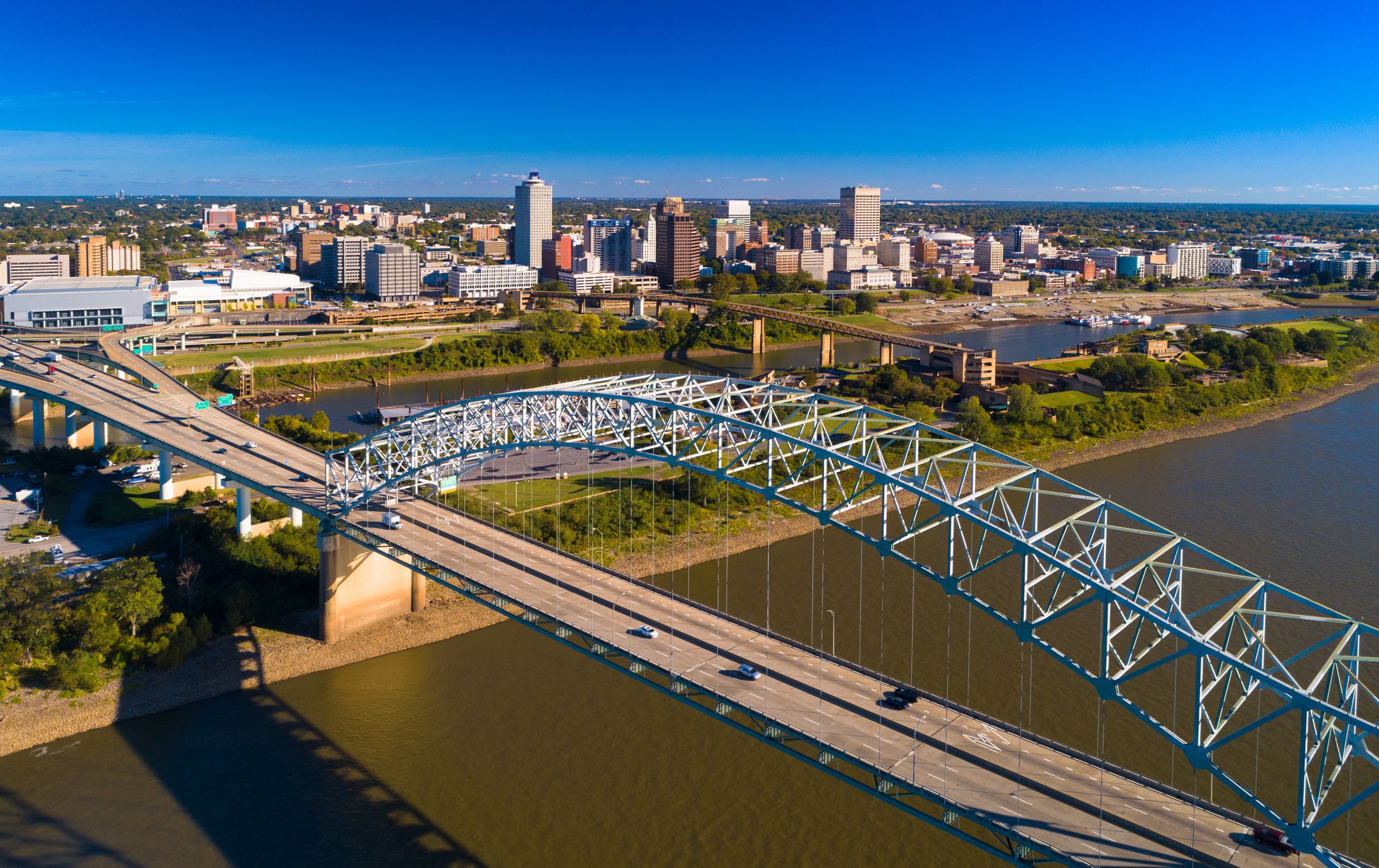 Downtown Memphis skyline aerial view with the Hernando De Soto bridge and the Mississippi River and Mud Island in the foreground.