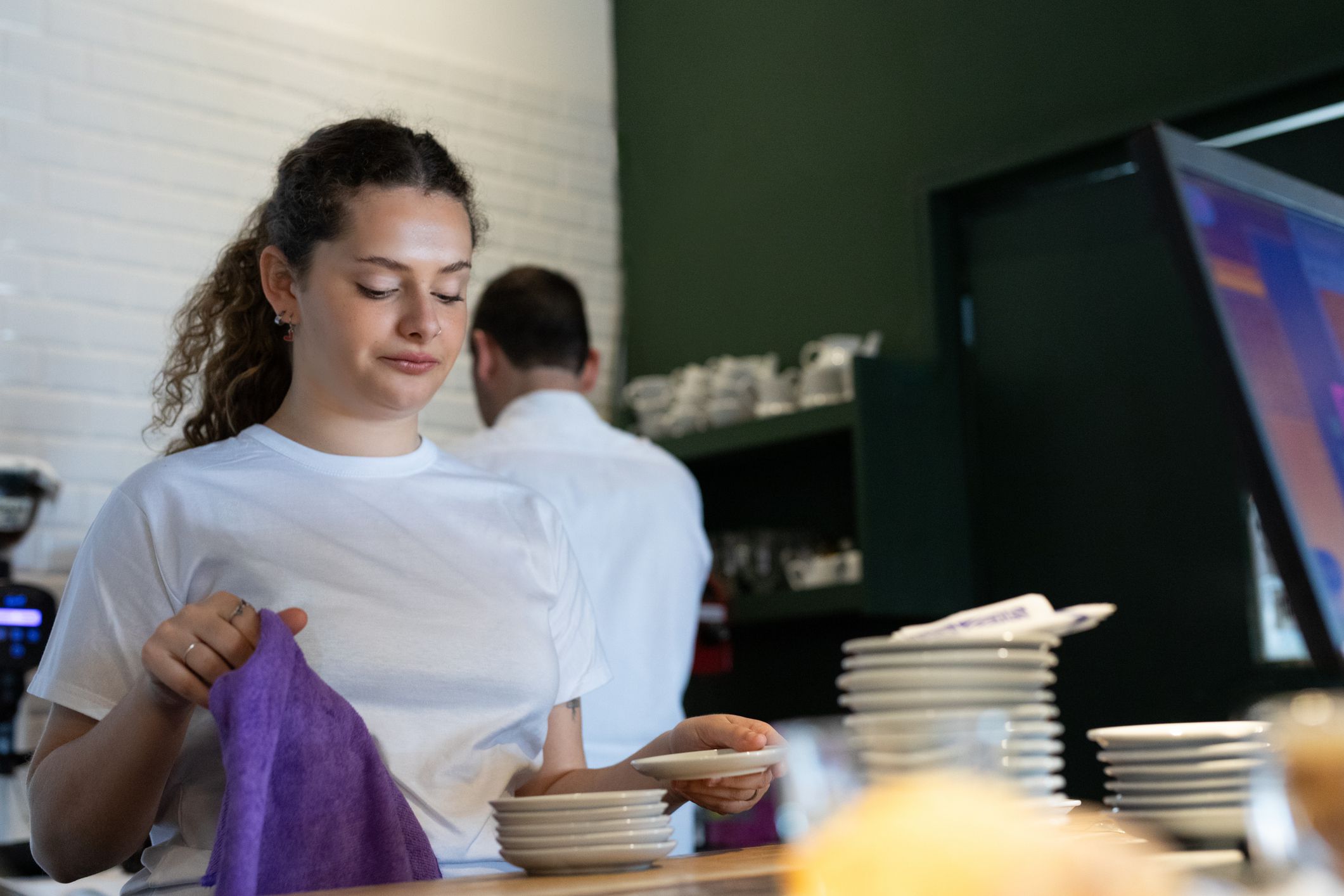 Young woman on her first day of work learning in a coffee shop - Buenos Aires - Argentina