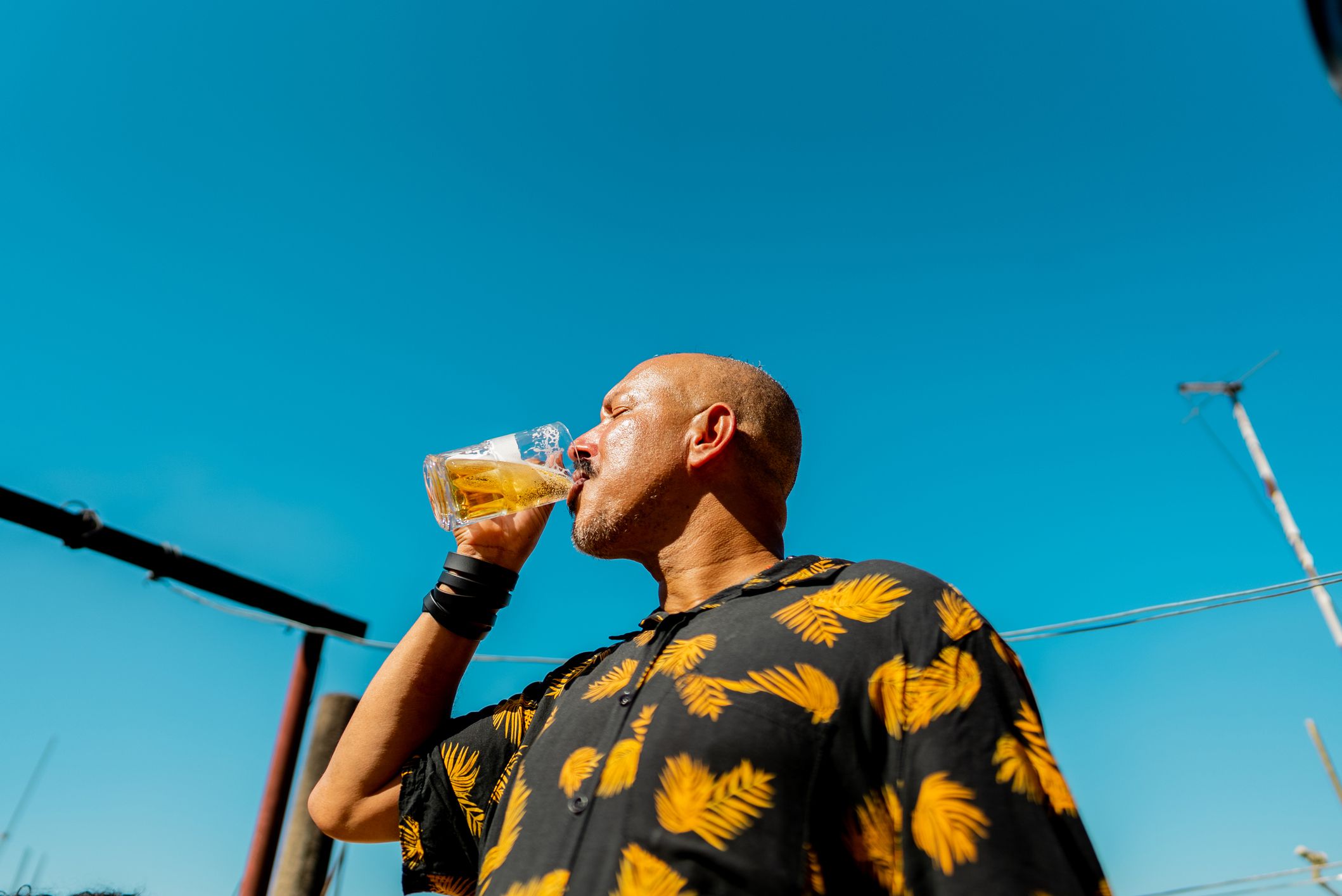 Mature man drinking beer outdoors