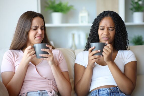 Friends tasting disgusting coffee at home