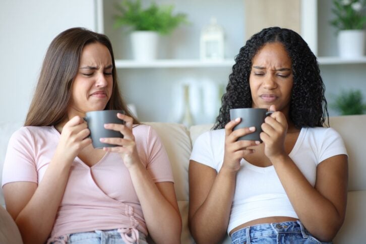 Friends tasting disgusting coffee at home