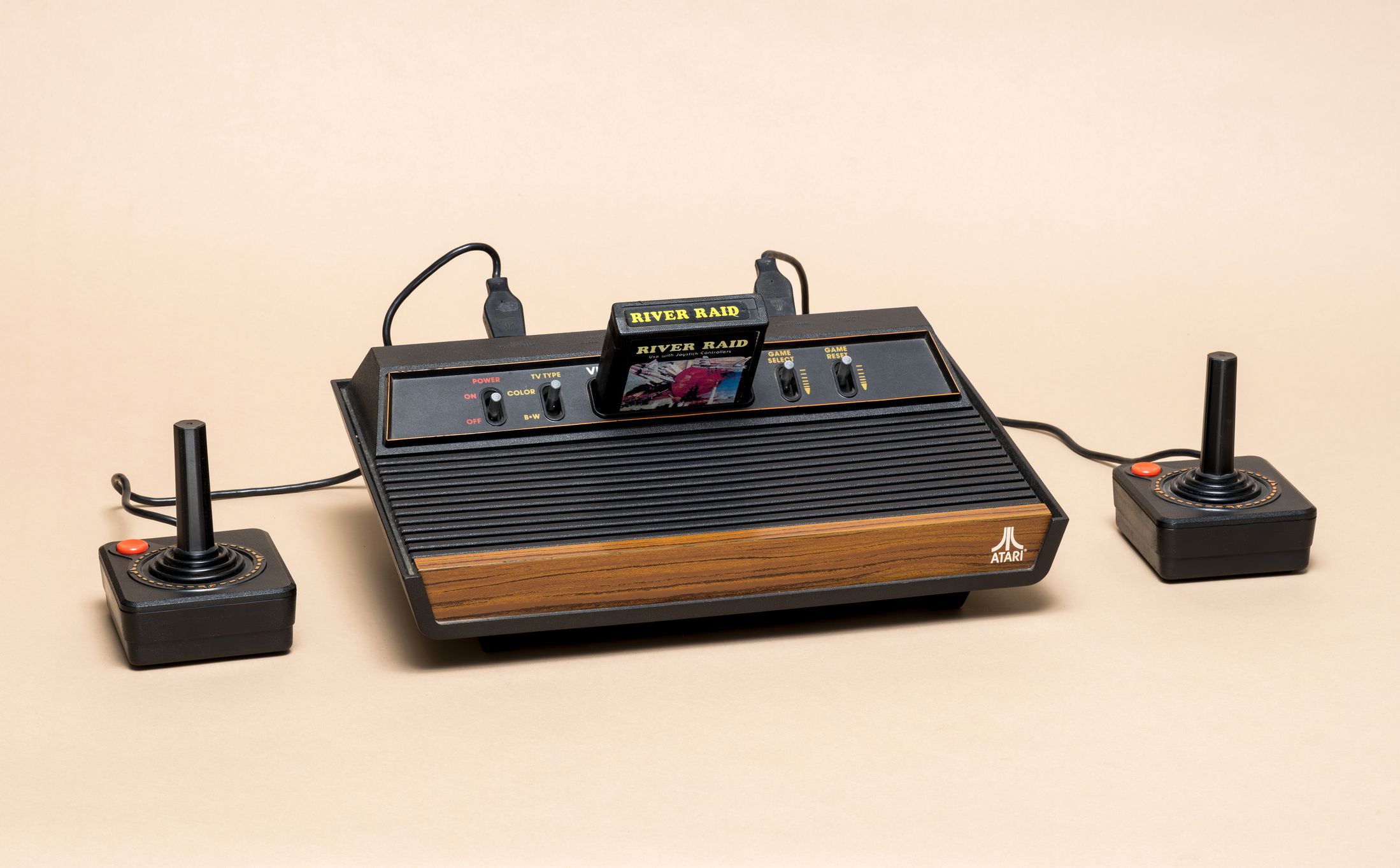Pavia, Lombardy, Italy - November 23, 2024: Atari 2600 console from 1976 at Ctrl+Alt Museum. The cartridge, from 1982, is the shooter game River Raid.