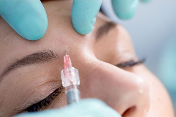 young woman receiving botox injection