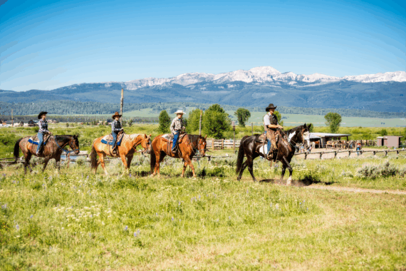 Family at a dude ranch riding horses in Montana