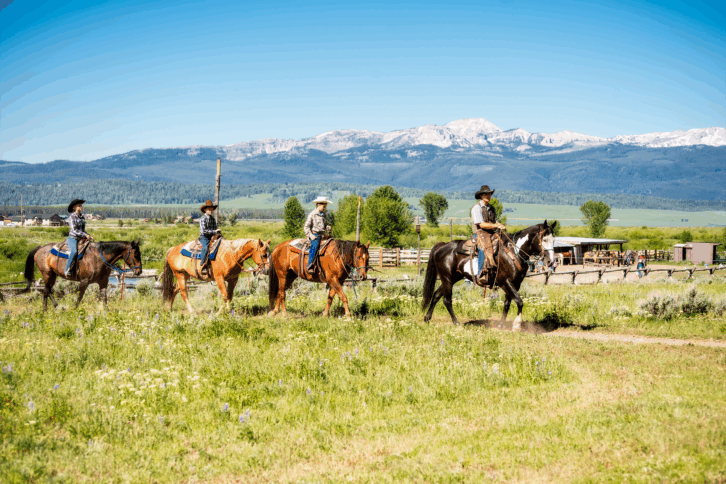 Family at a dude ranch riding horses in Montana