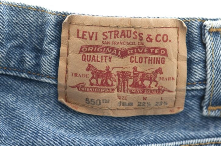 Weybridge, England-April 13, 2011. Close up of the Levei Strauss label on an old pair of levi\\\'s jeans. Levi\\\'s are made by Levi Strauss and Company. They created the first pair of blue jeans in 1873.
