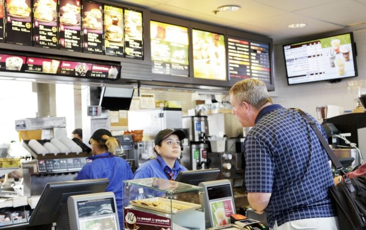 Chicago, USA - September 12, 2011: Traveler passing through Chicago O\'Hare International Airport  terminal orders fast food from McDonalds.