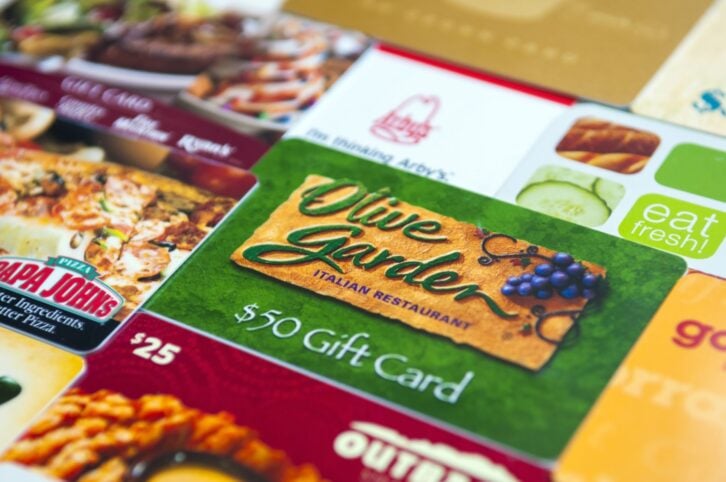 Indialantic, FL, USA - July 29, 2011: A variety of restaurant gift cards, including Olive Garden, Golden Corral, Subway, Arby's, Outback Steakhouse, and Papa John's.