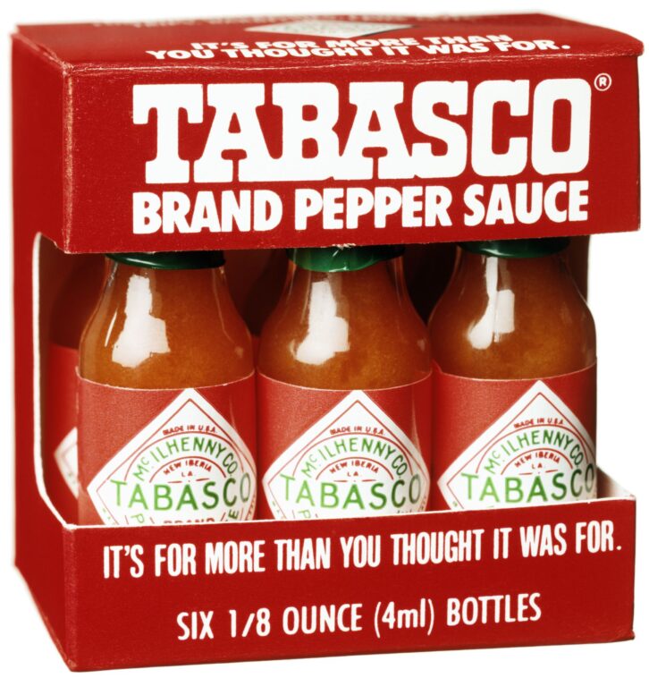 Truro, MA, USA - January 5, 2012. Three bottles of Tabasco red pepper sauce against white background.Tabasco sauce is the brand name for a hot sauce produced by US-based McIlhenny Company of Avery Island, Louisiana.