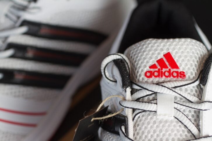 Red Adidas logo on a white nylon running shoe
