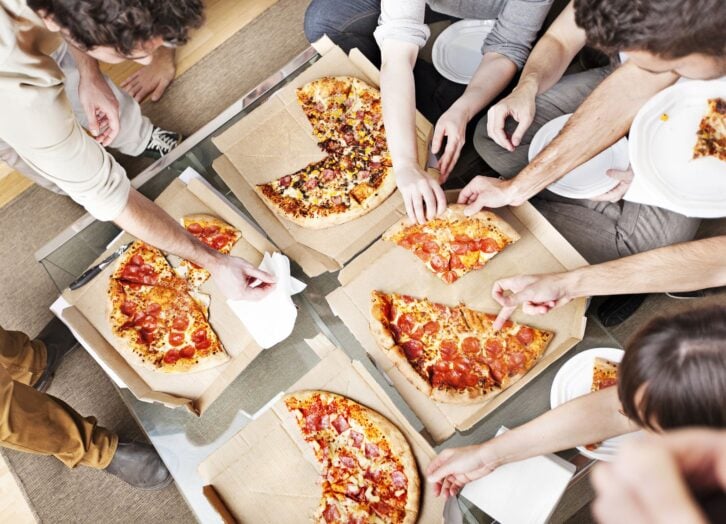 People taking pizza slices