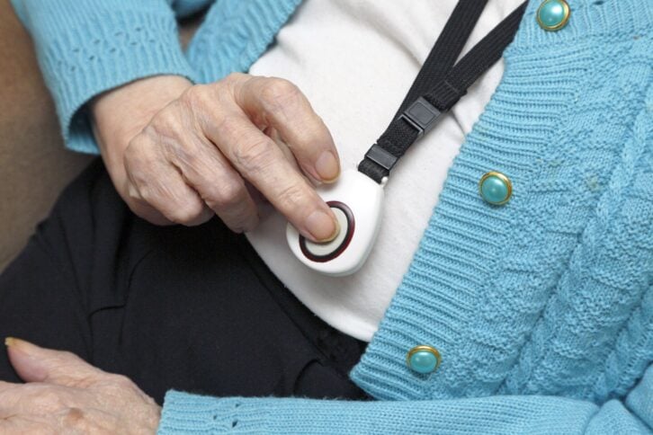 senior pressing medical alert system necklace