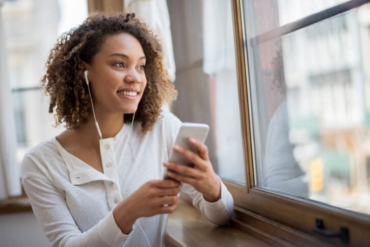 woman using app to listen to music
