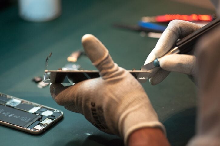 A technician repairing a mobile device