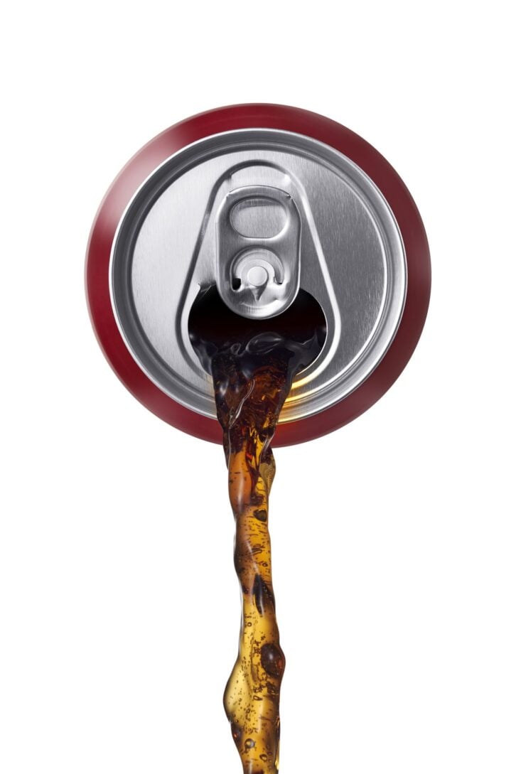 can of cola being poured, front view
