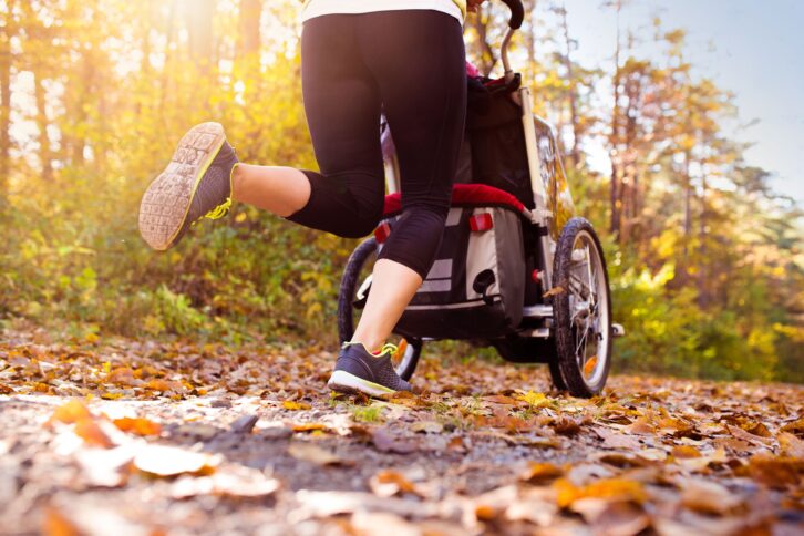 woman jogging with stroller outside