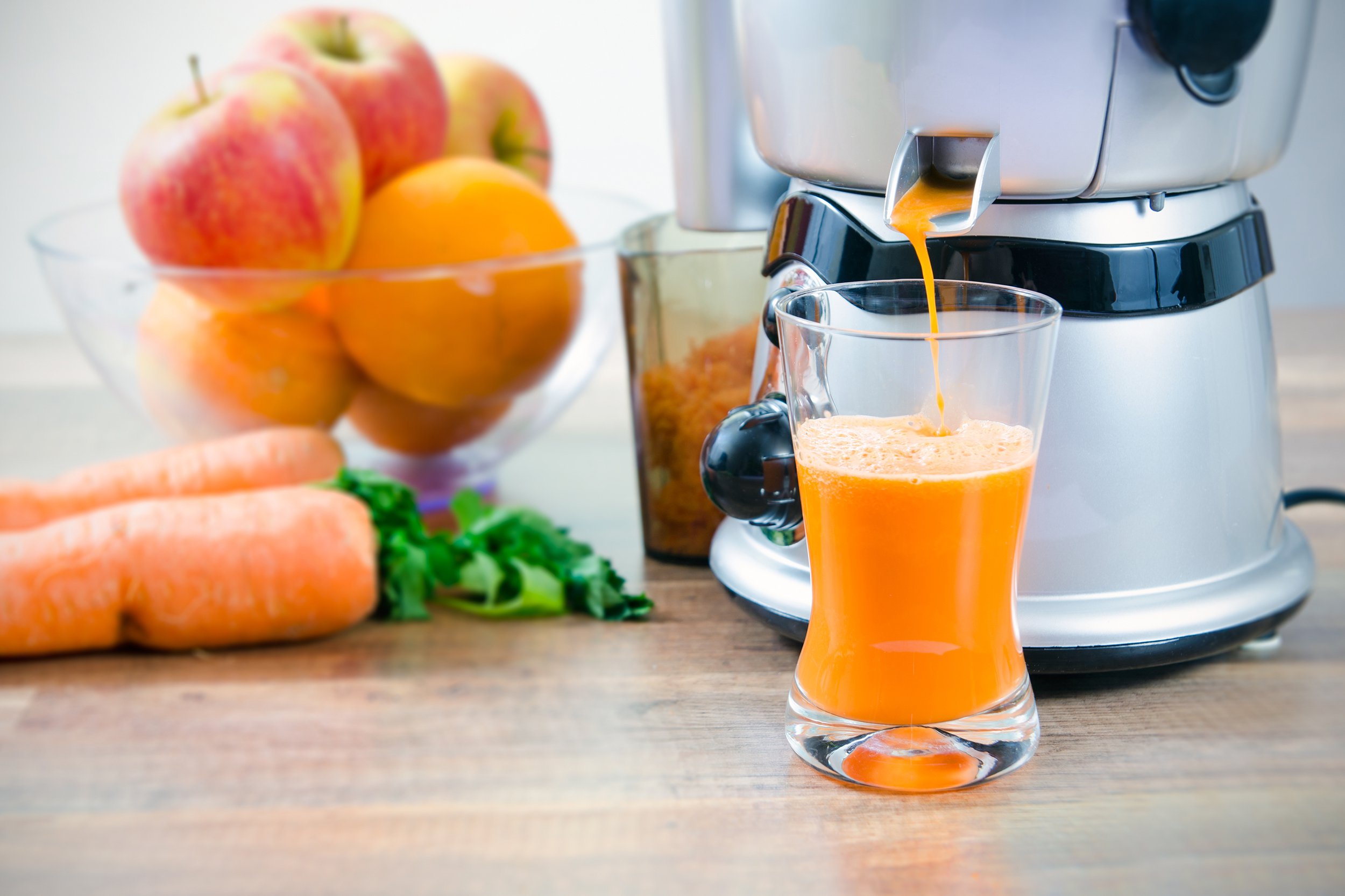 fruits being juiced by juicer