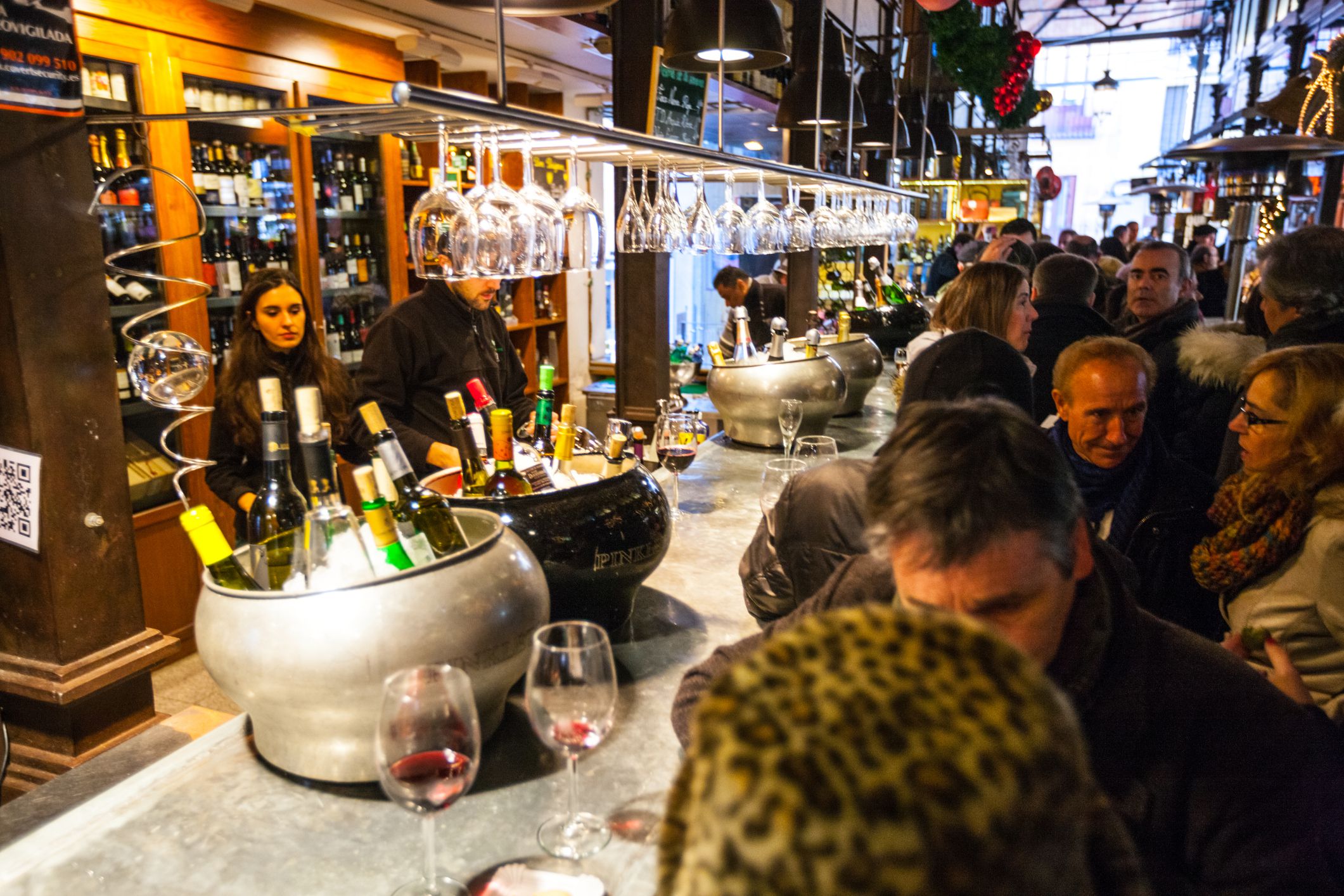 Madrid, Spain - December 22, 2013: People tasting wine at Mercado San Miguel, Madrid, Spain