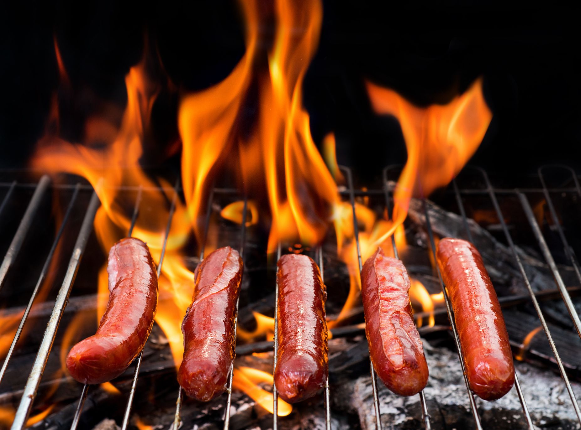 grill concept with flame. BBQ with fiery sausages on the grill