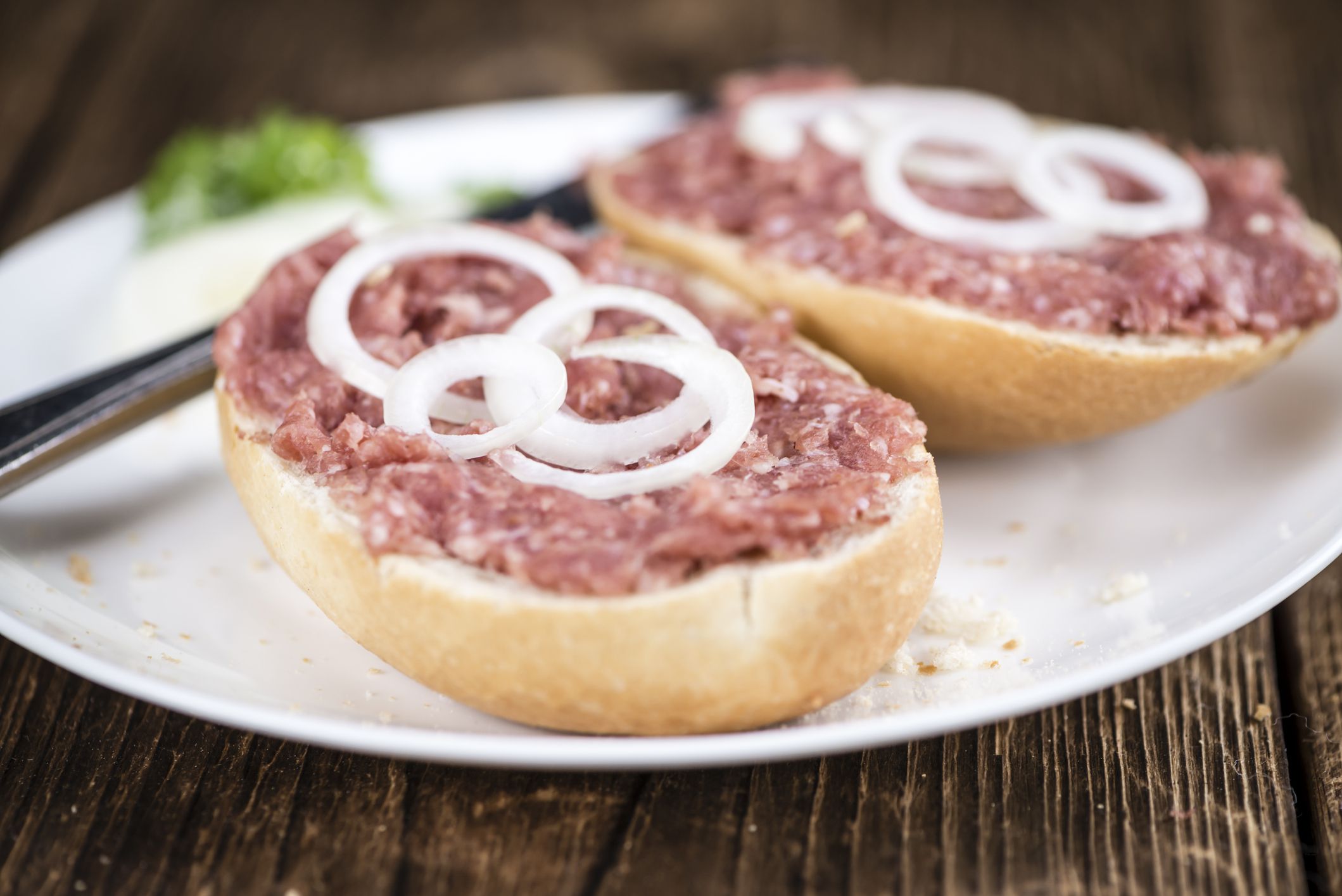 Bun with Mett (German cuisine; selective focus) on wooden background